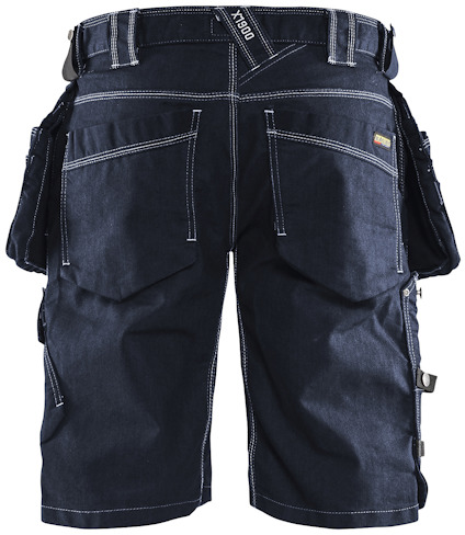 Arbetsbyxor i jeansstil med fickor. Mörkblå färg med kontrasterande vita sömmar.