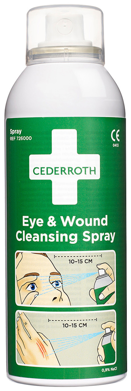 Grön flaska med vit kork, märkt "Cederroth Eye & Wound Cleansing Spray". Illustration visar användning och avstånd 10-15 cm.