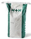 Vit och grön säck med texten "H+H Blokfix Blockfix" och "20 kg".