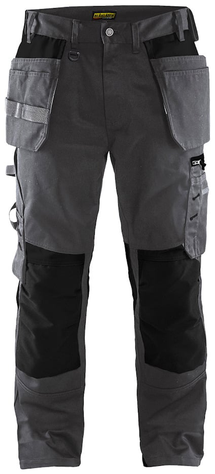 Arbetsbyxor i mörkgrått med svarta knäskydd, flera fickor och hållare.