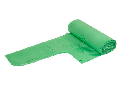 Grön komposterbar plastpåse i en rulle, delvis utrullad med symboler och text synliga.