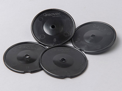 Fyra svarta plastbrickor med texten "Isover" och "8", "13" tryckt på dem, placerade på en ljus yta.