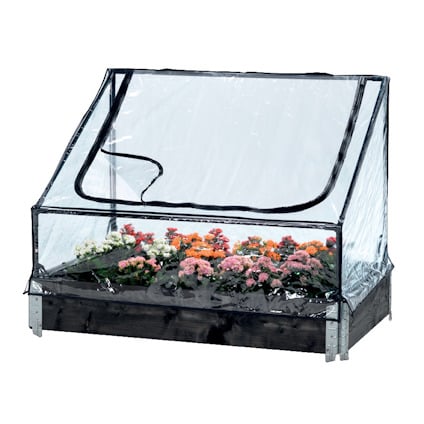 Växthus med transparent plastöverdrag och blixtlåsöppning över en odlingskrage. Inuti finns flera blommor.
