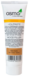 Vit tub märkt "Osmo Wood Filler 7304 Eiche Oak-Chêne-Tammi" med text på flera språk.
